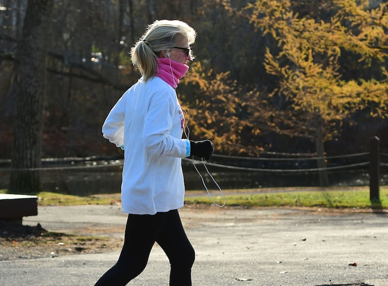 A woman is seen jogging near Buckingham Pond on Thursday, Nov. 19, 2020 in Albany, N.Y.