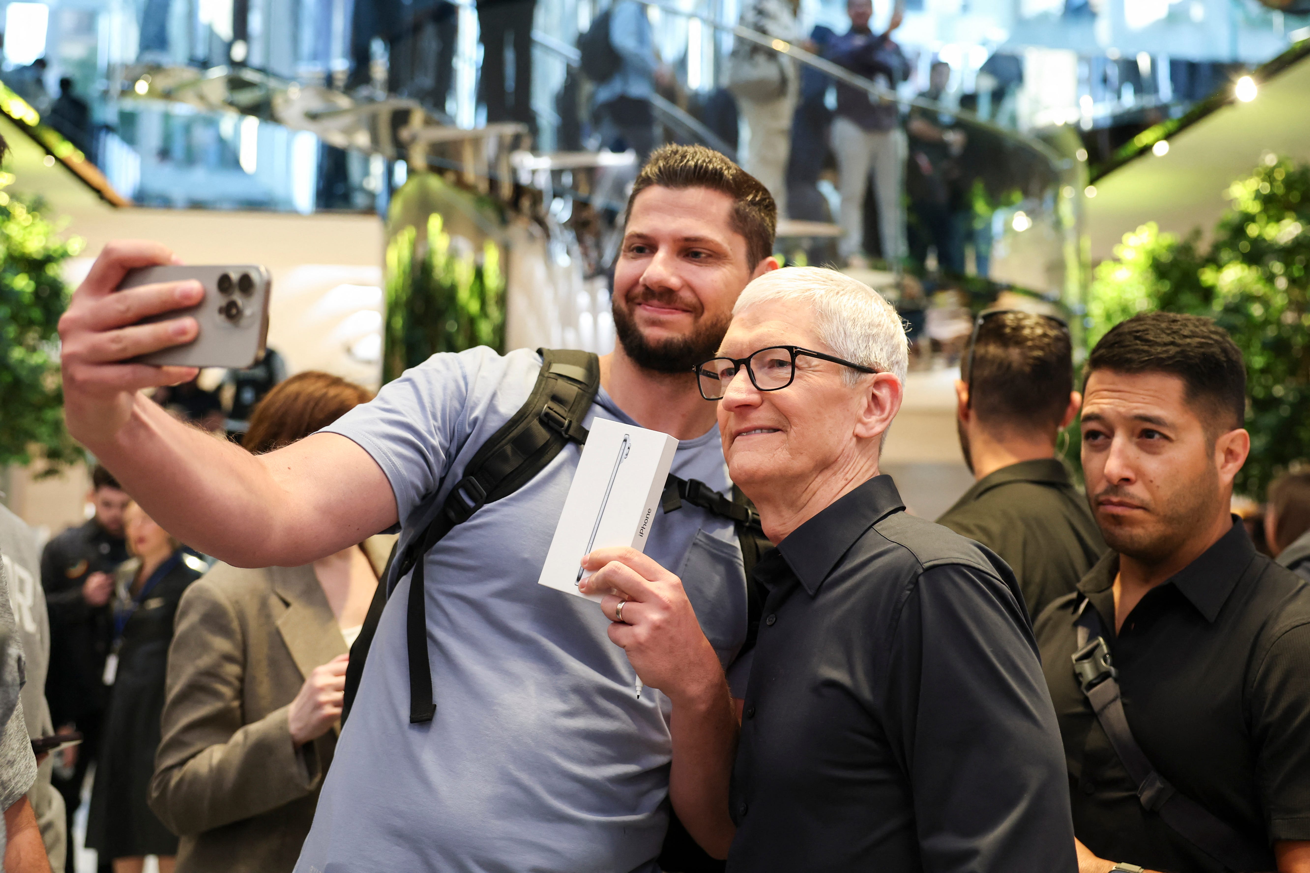 Keith Swiader, who was first in line at New York City's Fifth Avenue location, posing with Tim Cook.