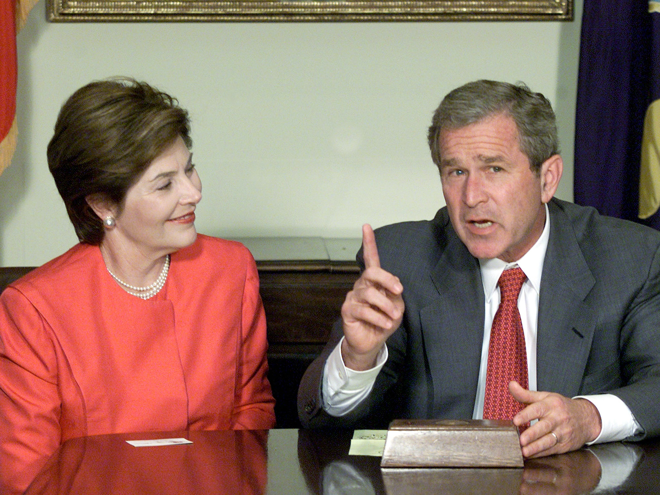 George W. Bush and Laura Bush sit together in the White House's Roosevelt Room.