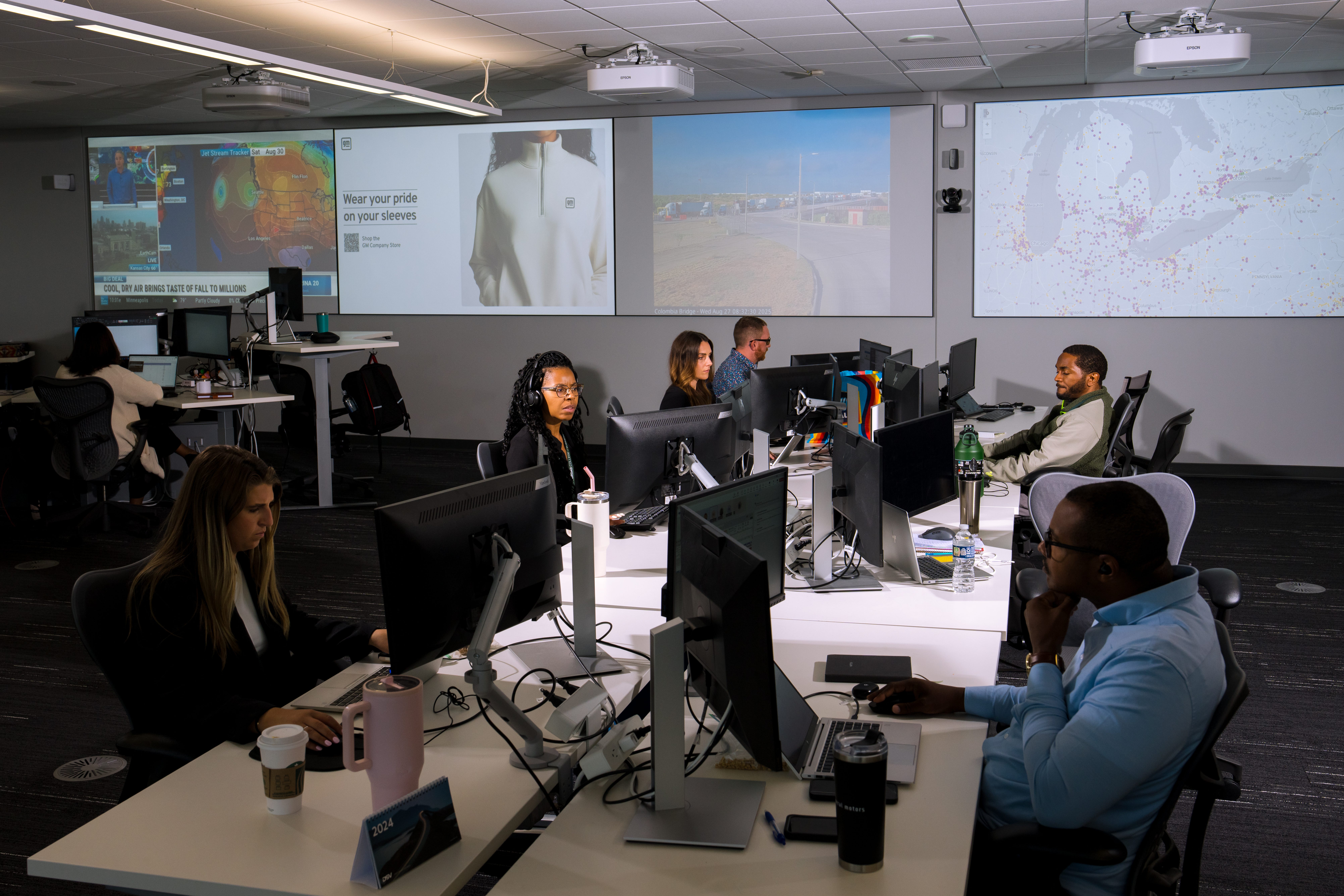 A team watch the weather on a monitor at GM's Technical Center in Warren, Michig