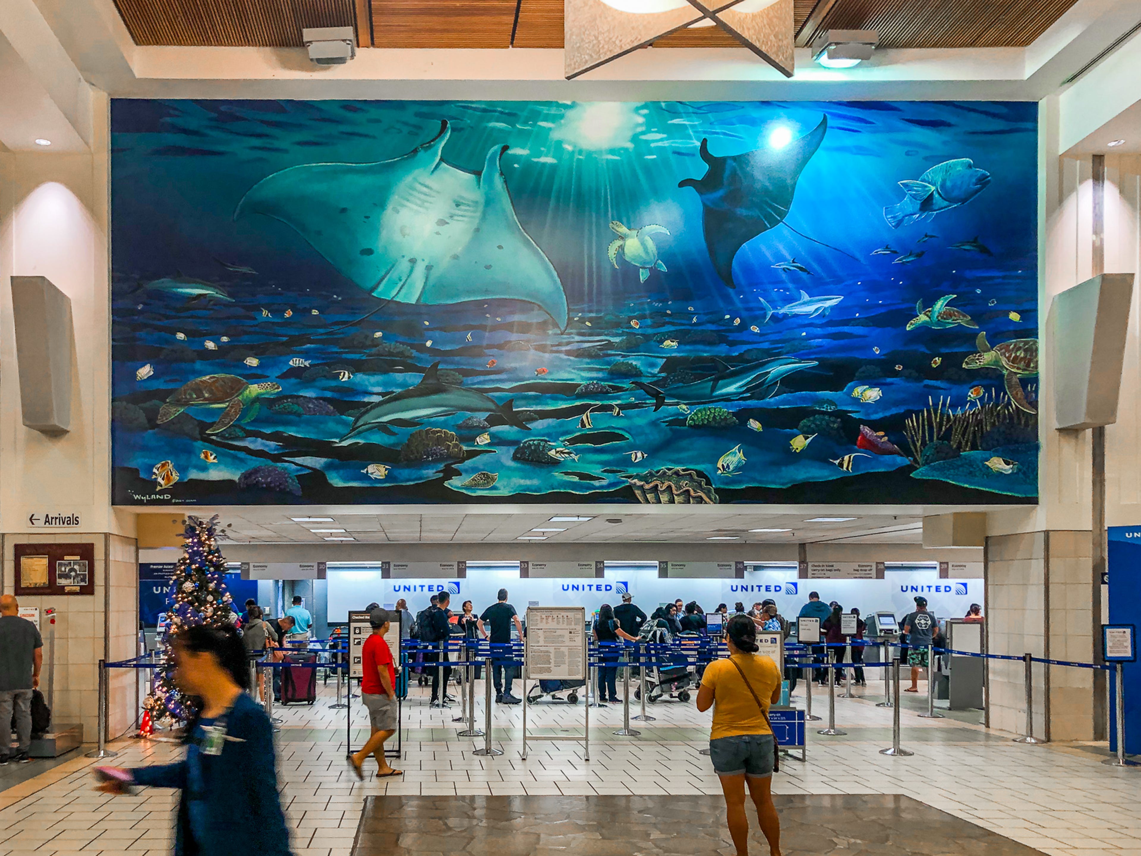 A mural above the United check-in counter inside an airport