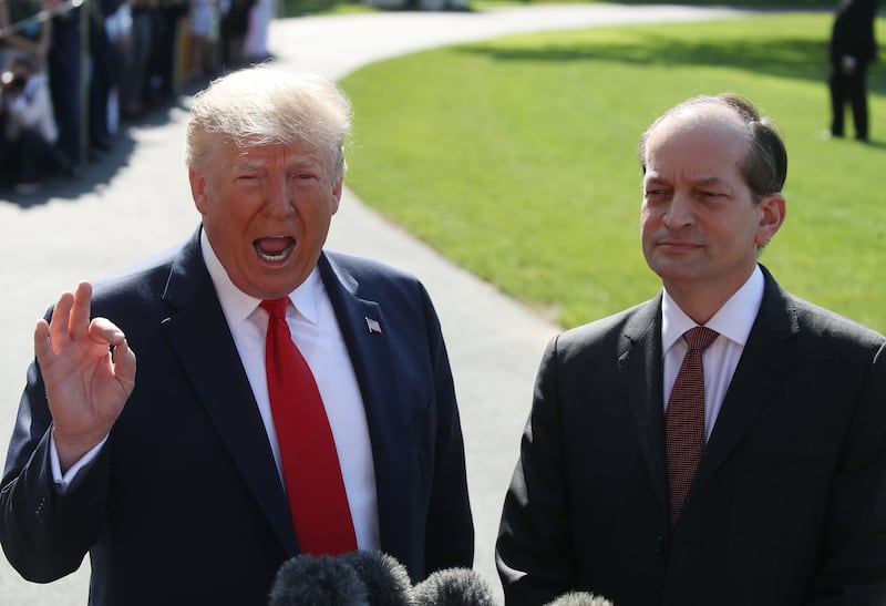 President Donald Trump standing with Labor Secretary Alex Acosta in July 2019 after he announced his resignation amid questions over his role in the Jeffrey Epstein plea deal a decade earlier.