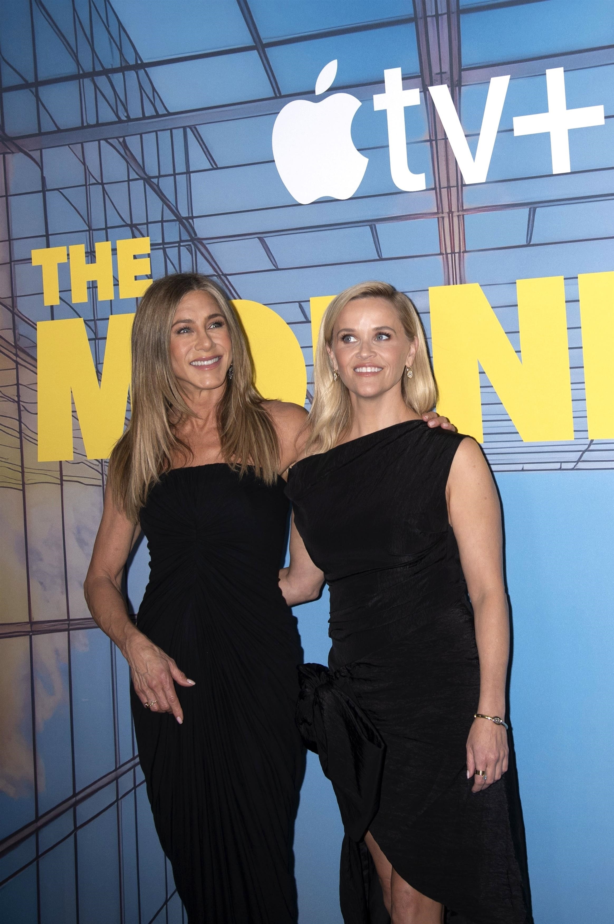 Jennifer Aniston and Reese Witherspoon at an event. 