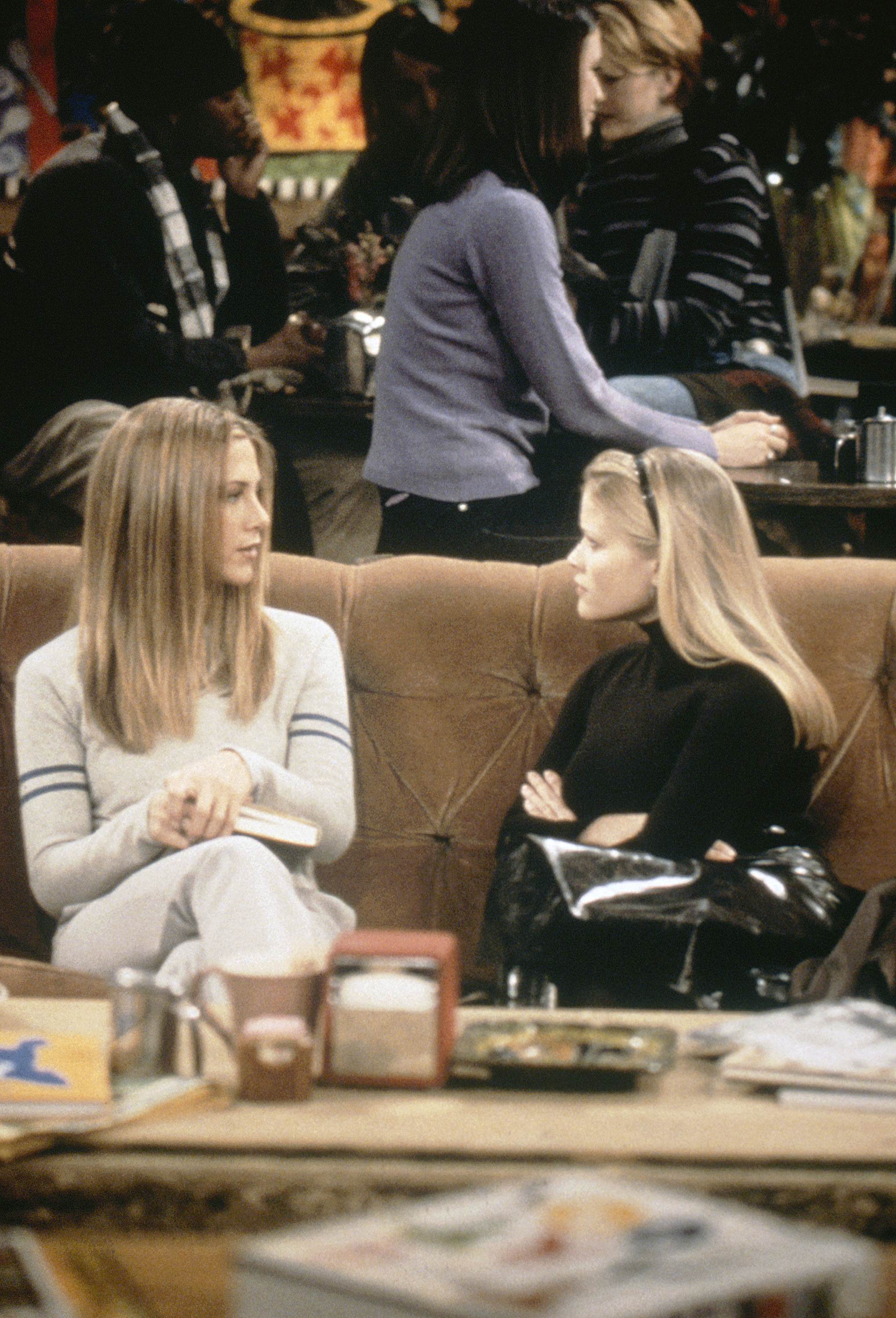 Jennifer Aniston and Reese Witherspoon on a couch. 