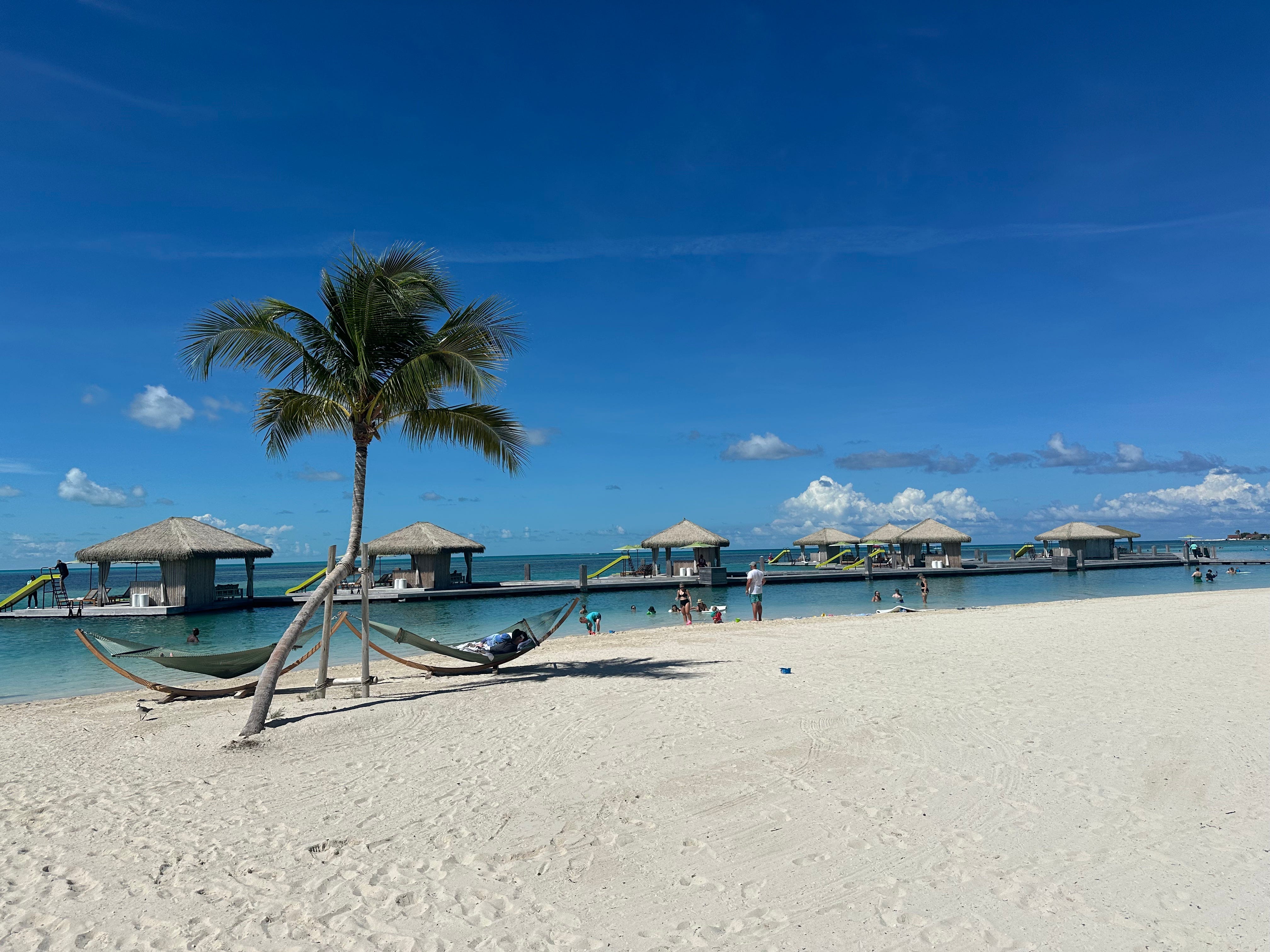 A private beach with palm trees and hammocks on Coco Cay.