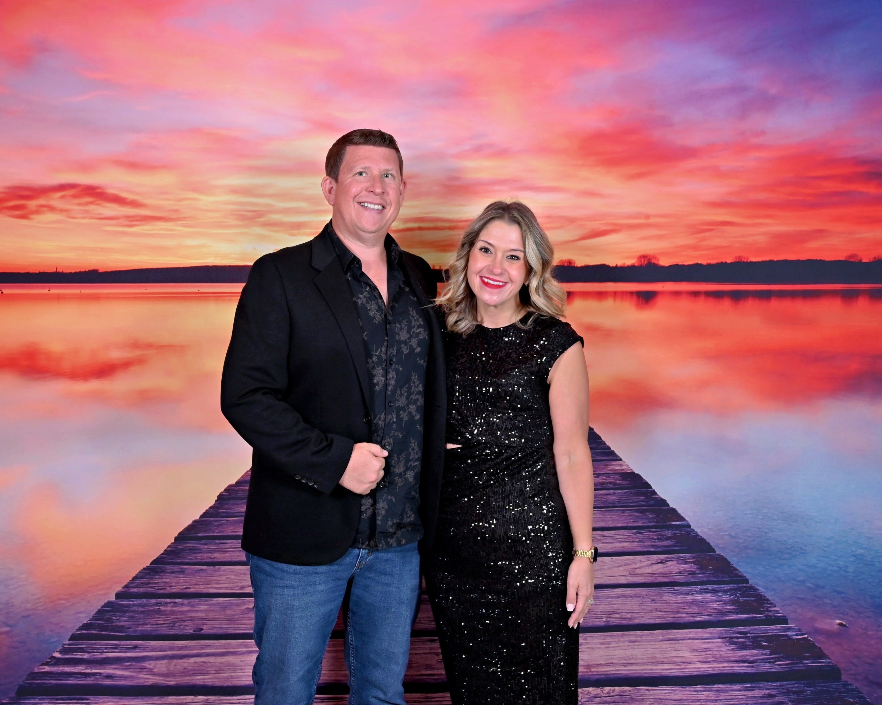 The author and her husband in front of a sunset backdrop.