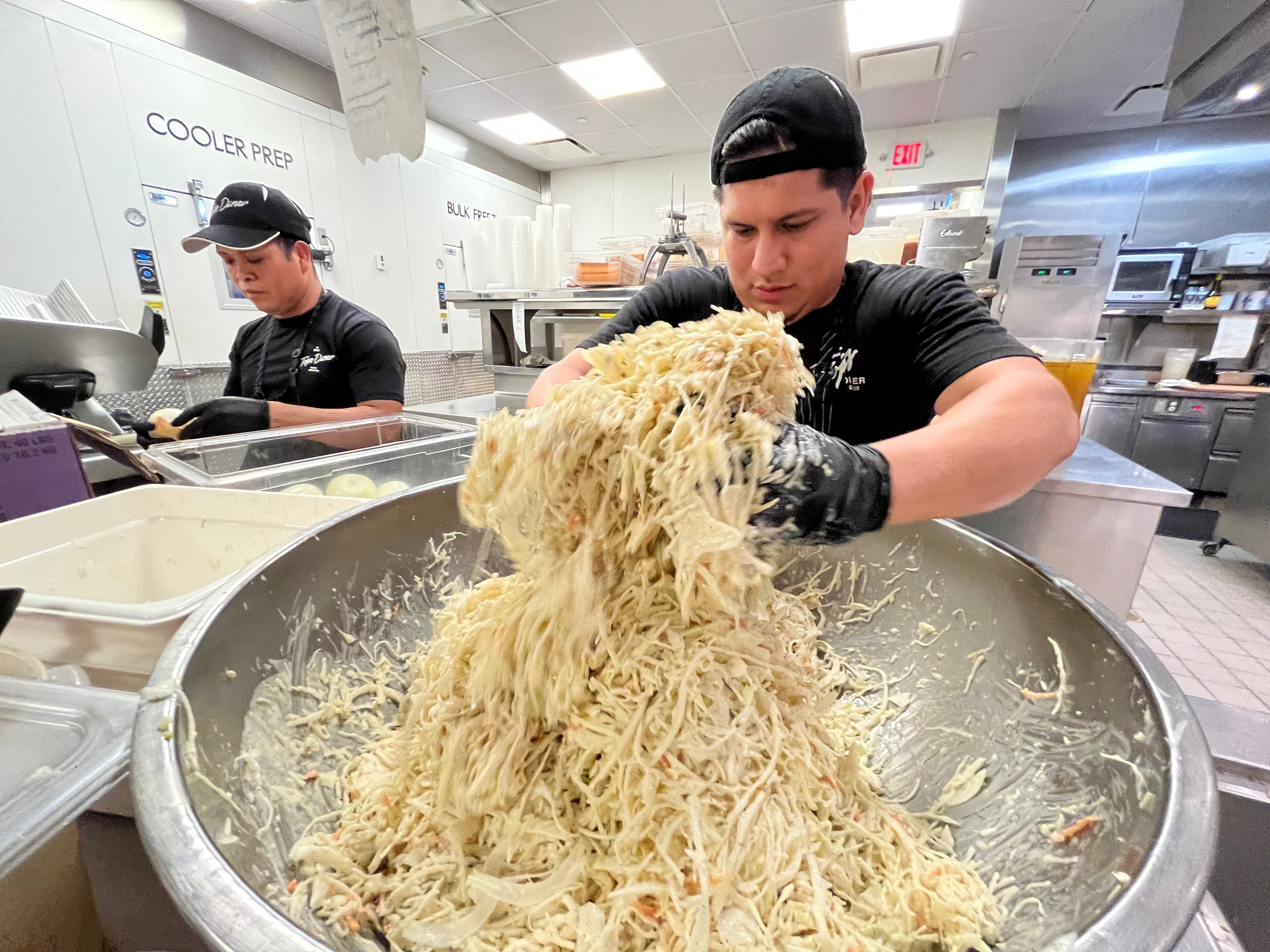 man tossing pasta