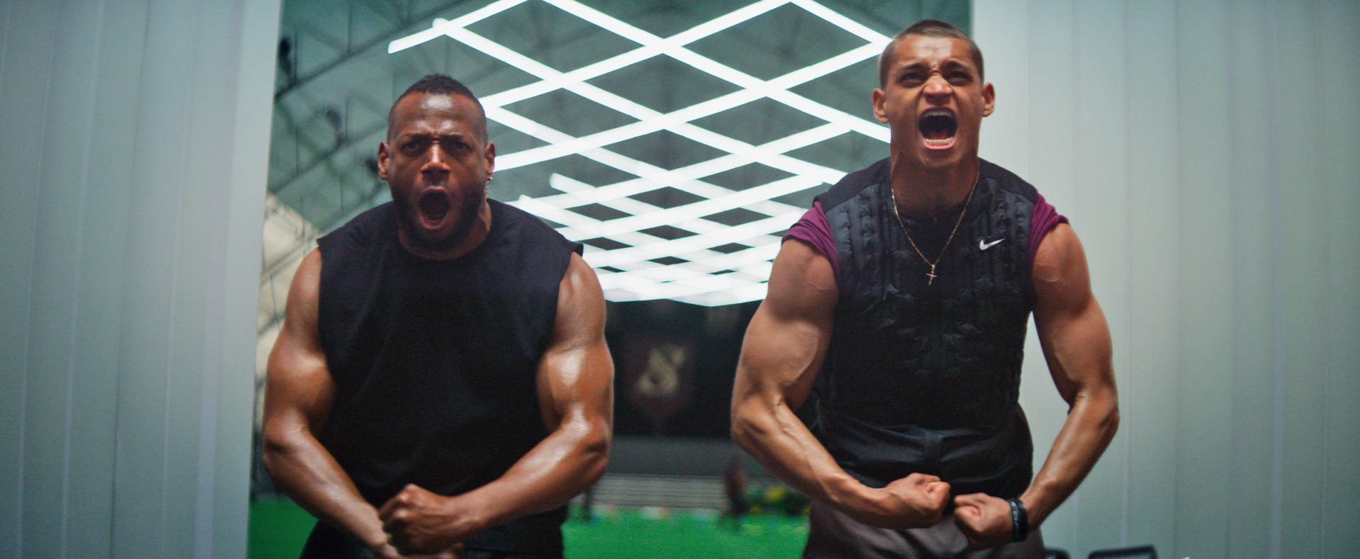 Marlon Wayans and Tyriq Withers flexing their muscles