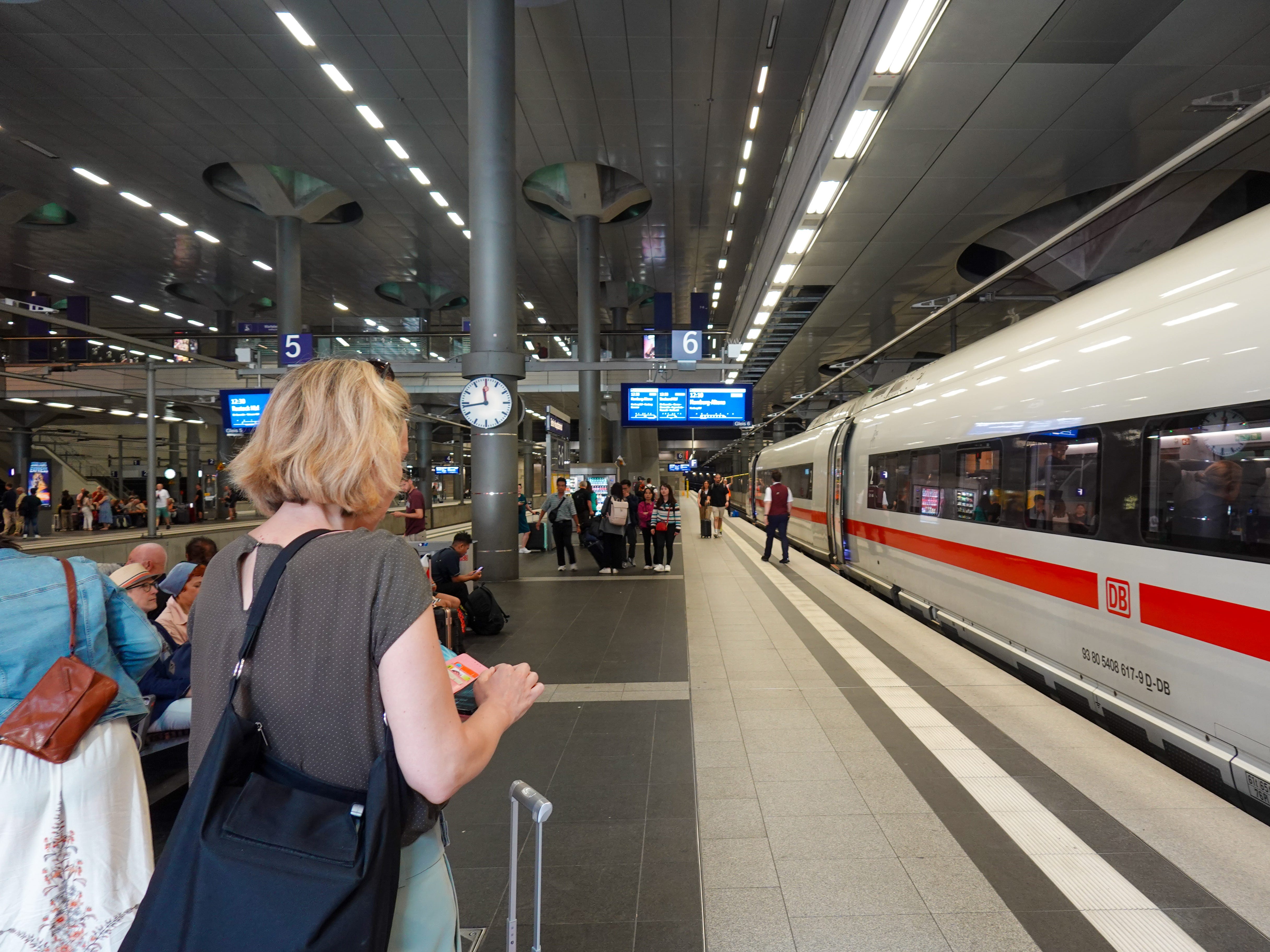 Passengers wait for an ICE long-distance train of Deutsche Bahn at Berlin Hauptbahnhof train station
