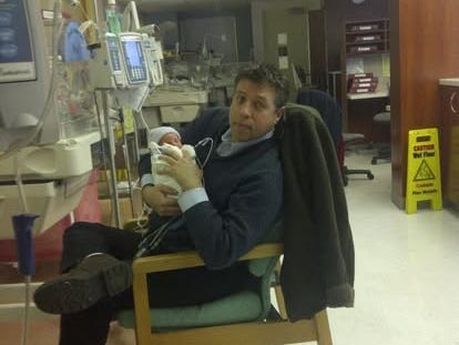 Man holding baby at the hospital