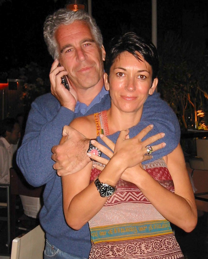 Jeffrey Epstein hugging Ghislaine Maxwell as he talks on a cell phone.