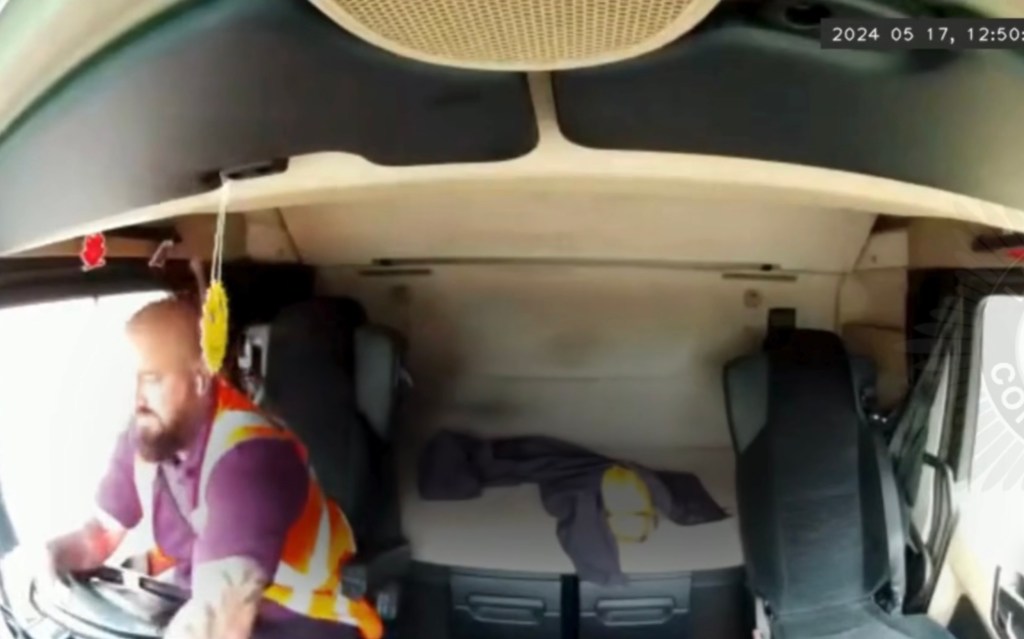 police photo shows platt behind the driver's wheel inside his truck