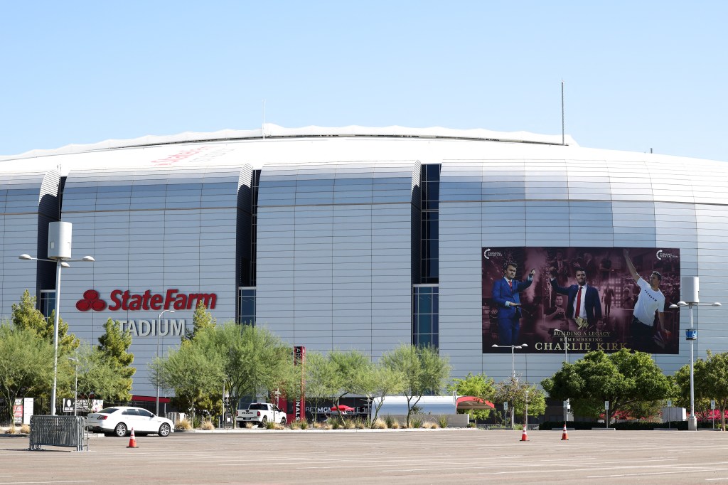 State Farm Stadium with a banner for Charlie Kirk's funeral.