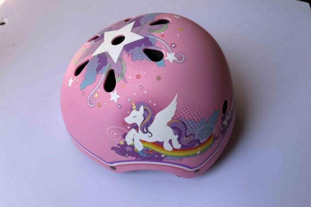Side view of a recalled YooxArmor Multi-Purpose Helmet, pink with a unicorn design.
