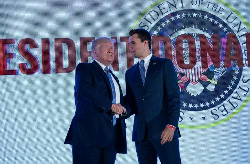 President Trump shaking hands with Charlie Kirk.