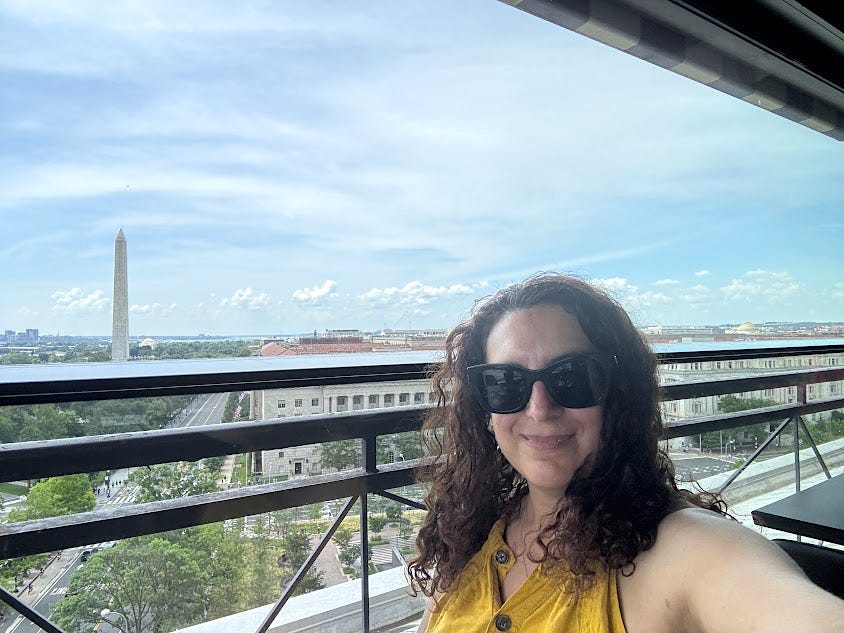 The author smiling with a view of Washington, DC, in the background.