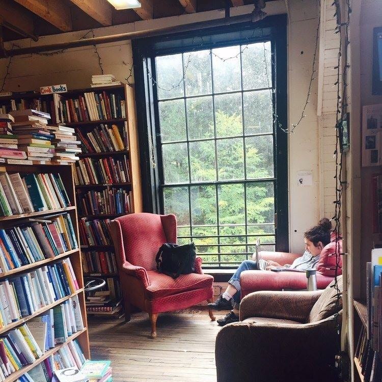 Woman by a window reading