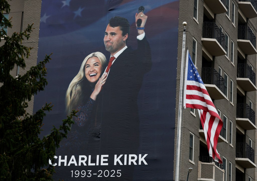 A banner honoring Charlie Kirk and Erika Kirk is displayed on the Heritage Foundation building in Washington.