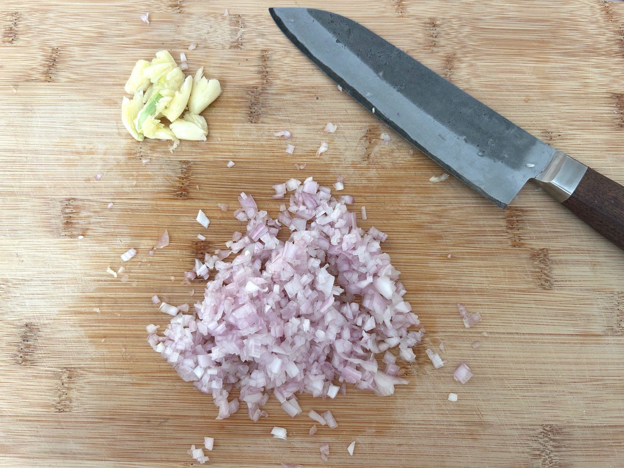 Chopped shallots and smashed garlic for Meghan Markle's chicken and bread salad