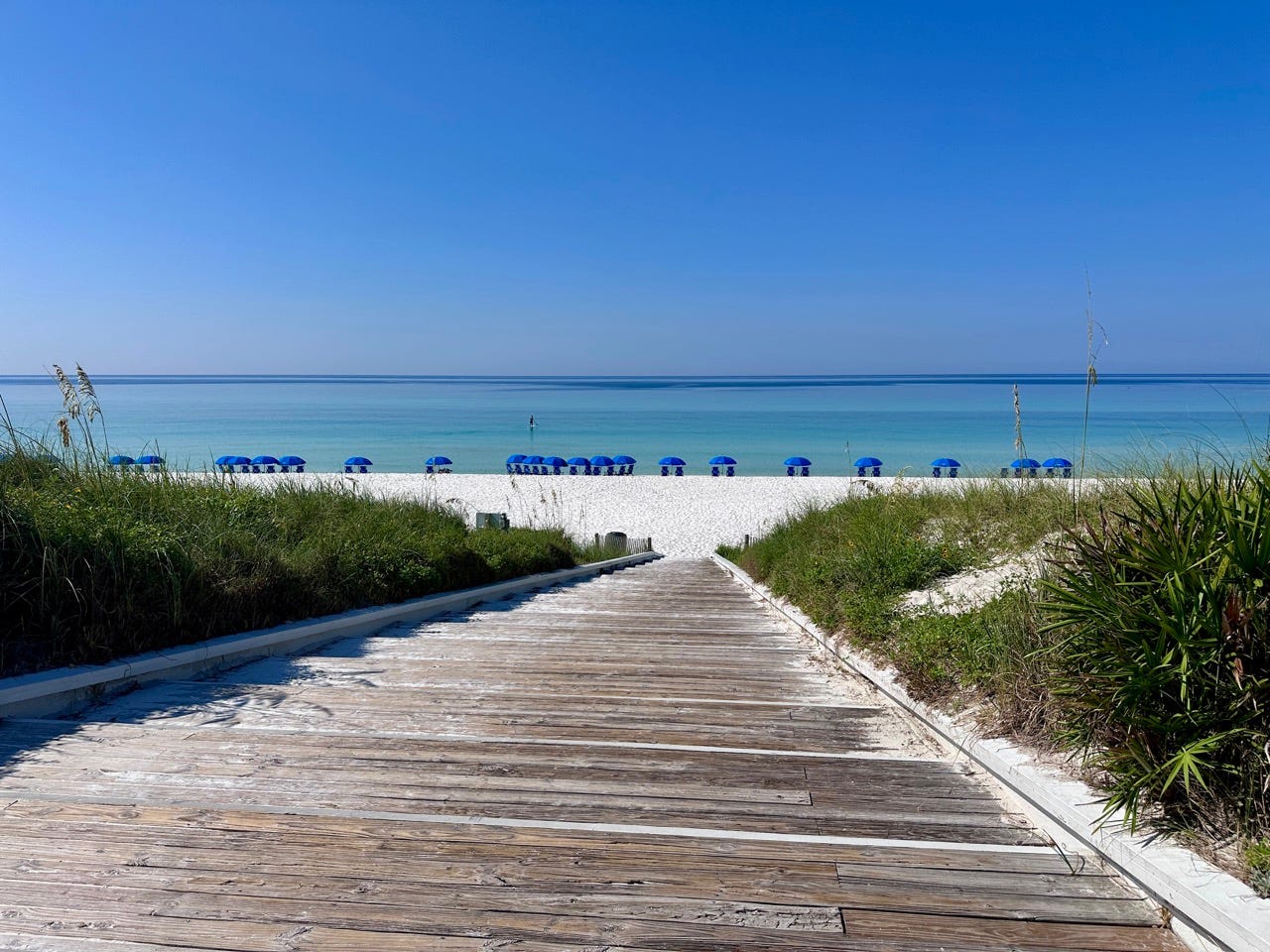 View of boardwalk leading down to sand at Seaside