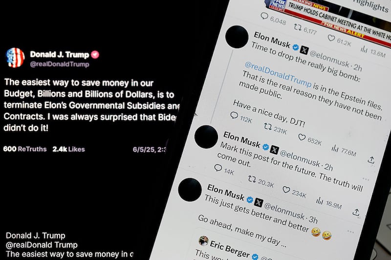 Social media posts by U.S. President Donald Trump and Elon Musk are displayed on smartphones on June 05, 2025 in San Anselmo, California. U.S. President Donald Trump has threatened to revoke government contracts from Tesla and SpaceX CEO Elon Musk as a public feud escalates over Musk's criticism of the Trump administration's policies. (Photo Illustration by Justin Sullivan/Getty Images)