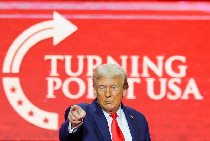 U.S. President Donald Trump points a finger onstage during a memorial service for slain conservative commentator Charlie Kirk at State Farm Stadium, in Glendale, Arizona, U.S., September 21, 2025.  REUTERS/Daniel Cole     TPX IMAGES OF THE DAY