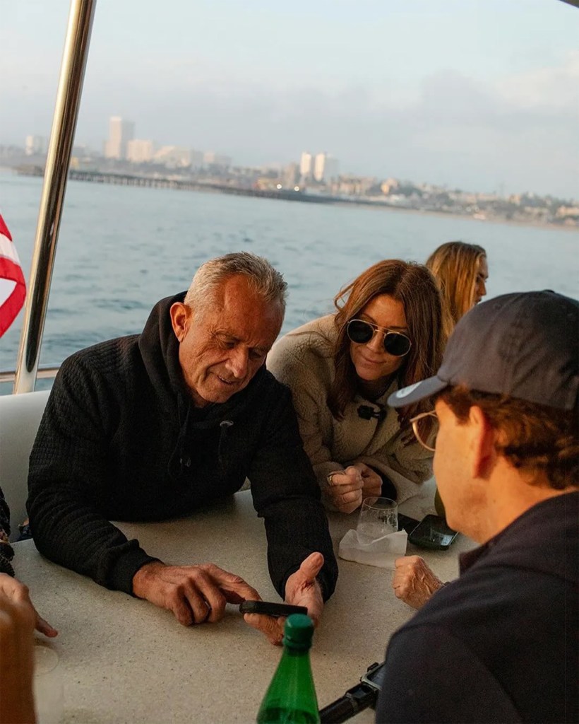 RFK Jr. on a boat explaining how he will remove chemicals from food to a group of people.