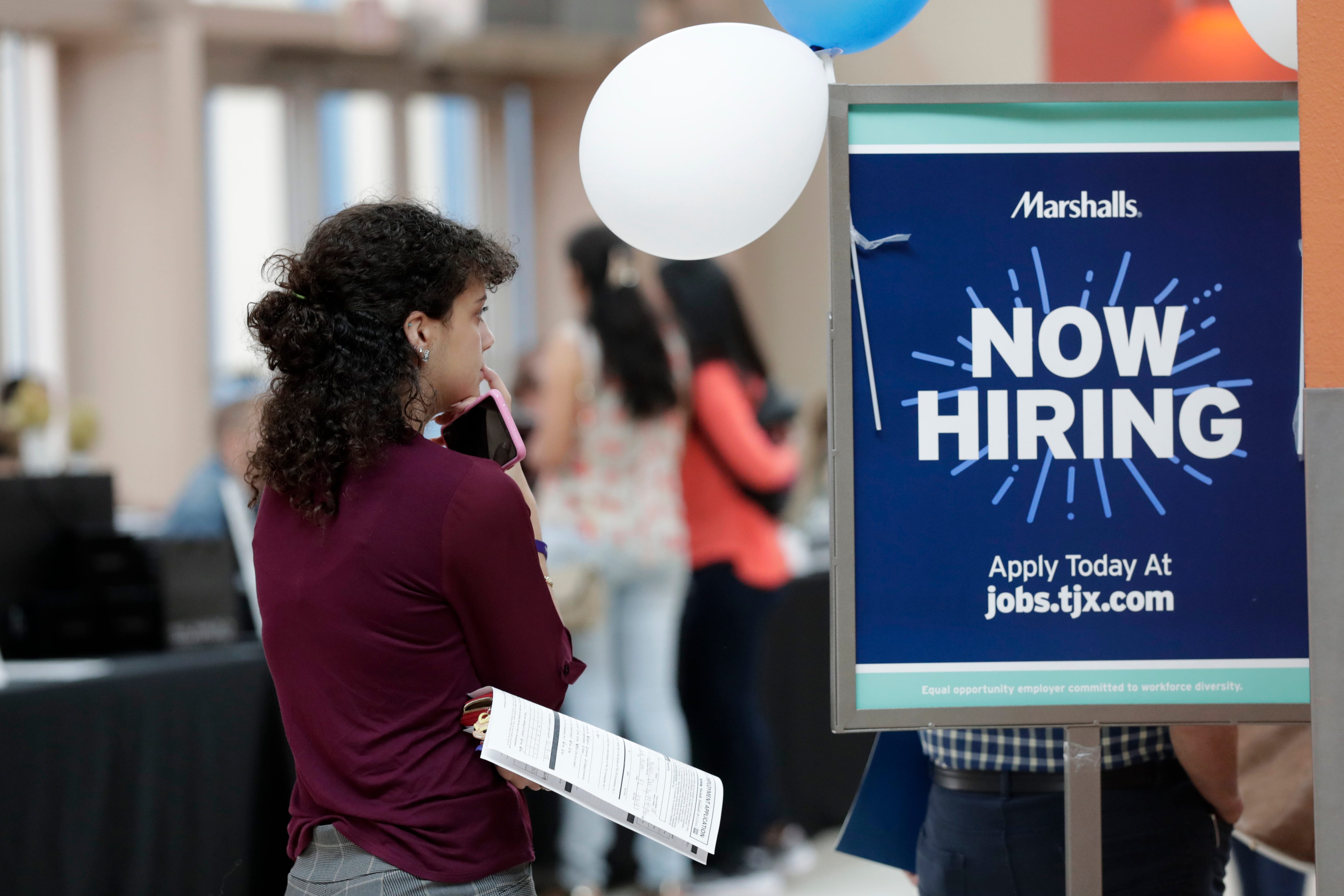 FILE - In this Oct. 1, 2019, file photo, Daisy Ronco waits in line to apply for a job with Marshalls during a job fair at Dolphin Mall in Miami. On Wednesday, Oct. 30, payroll processor ADP reports on how many jobs its survey estimates U.S. companies added in October. (AP Photo/Lynne Sladky, File)
