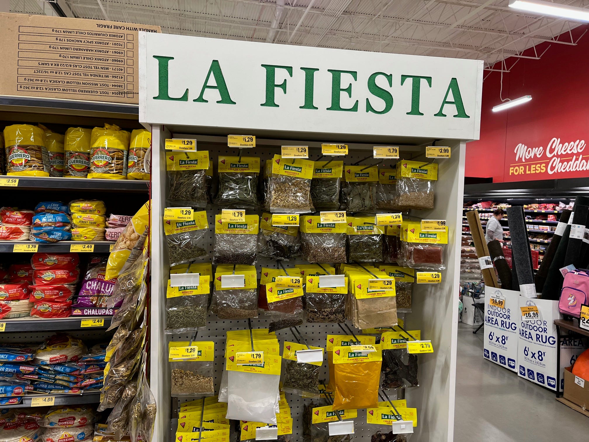 A selection of Mexican spices sit in packages on a shelf with the brand name