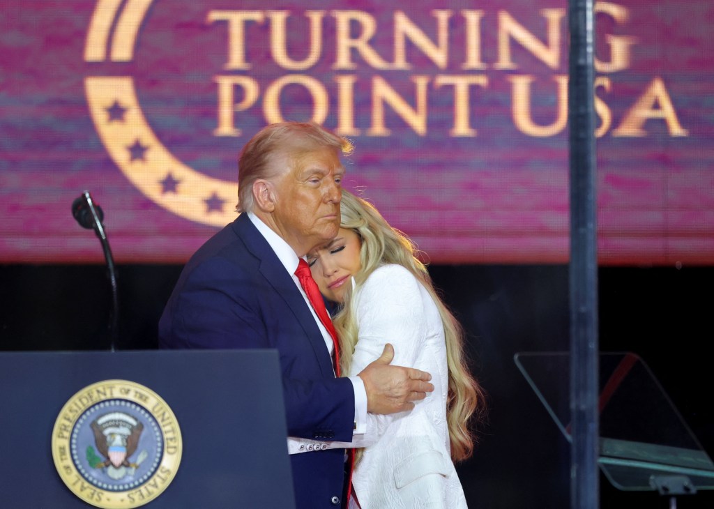 Donald Trump embraces Erika Kirk at a memorial service.