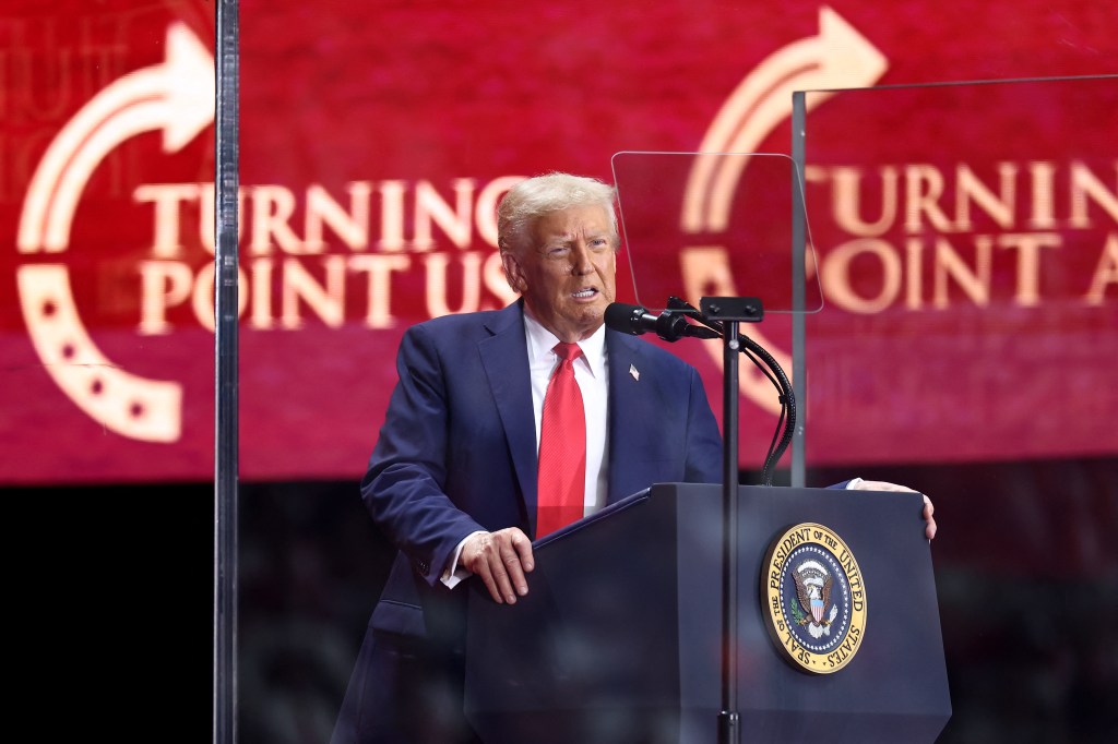People listen during a worship song at a memorial for Charlie Kirk.