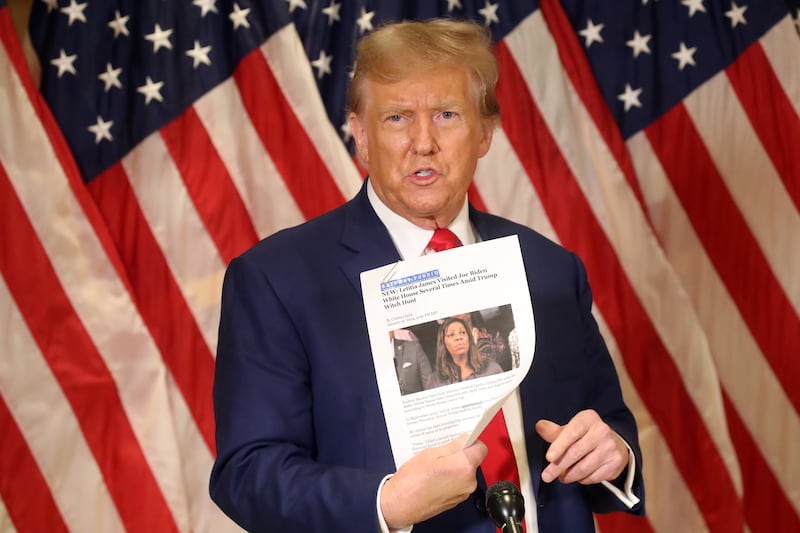 NEW YORK, NEW YORK - JANUARY 11: Former U.S. President Donald Trump holds up a news story about New York Attorney General Letitia James as he speaks to the media at one of his properties at 40 Wall Street following closing arguments at his civil fraud trial on January 11, 2024 in New York City. The former president, who is currently the front runner for the Republican nomination, attended the closing arguments for the trial which will now go to the judge for the penalty phase in which New York Attorney General Letitia James is seeking $370 million in damages and to prohibit Trump from doing business in the state.  (Photo by Spencer Platt/Getty Images)