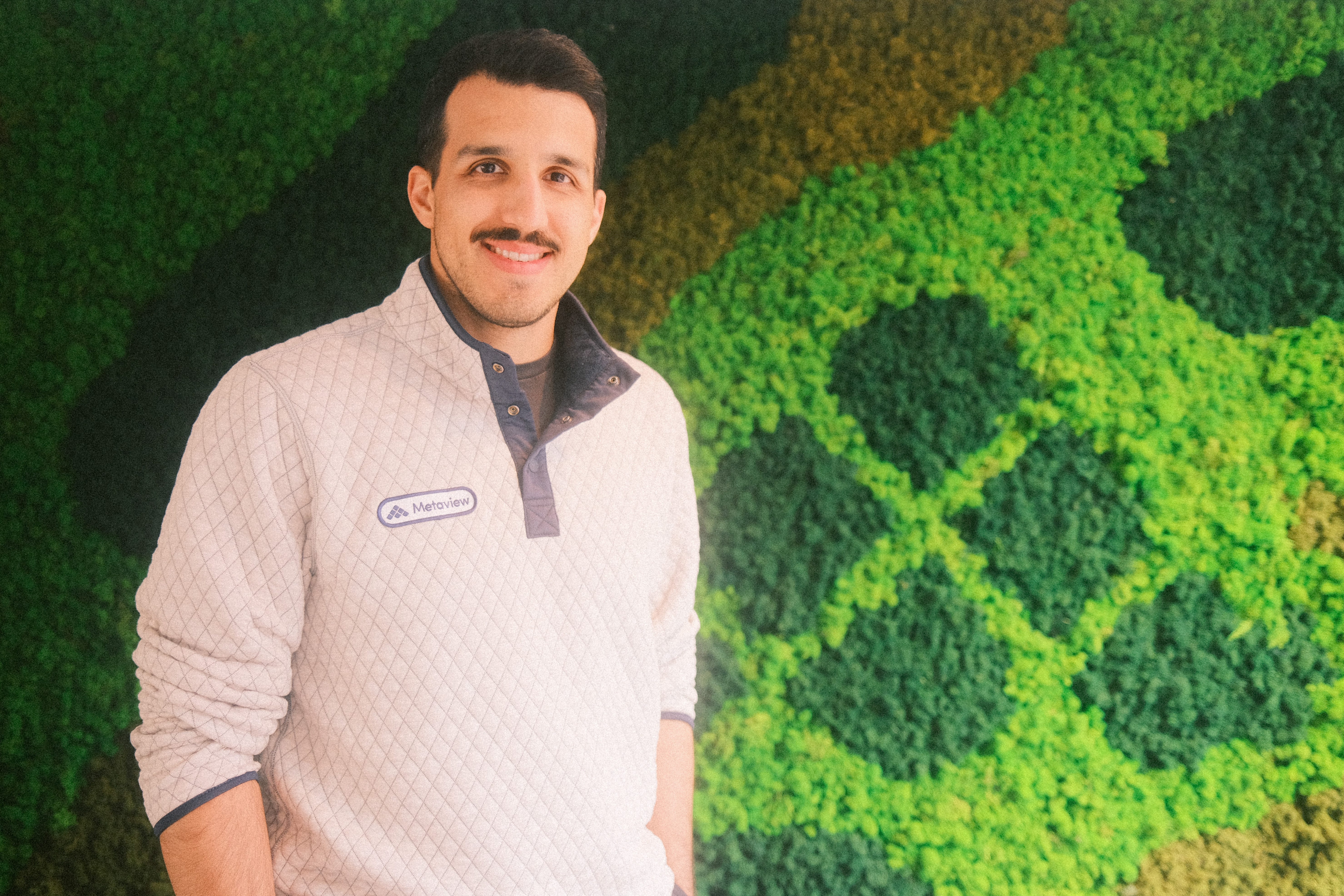 Shahriar Tajbakhsh standing in front of a green wall