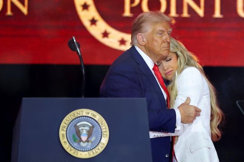 President Donald Trump embraces Erika Kirk, during a memorial service for her husband, Charlie Kirk, at State Farm Stadium in Arizona on September 21, 2025.