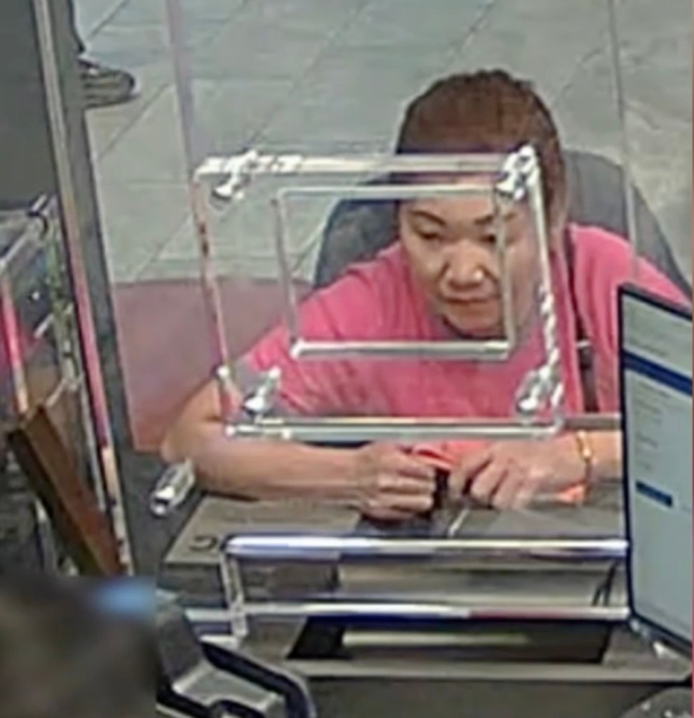 Qiuju Wu at a bank counter.