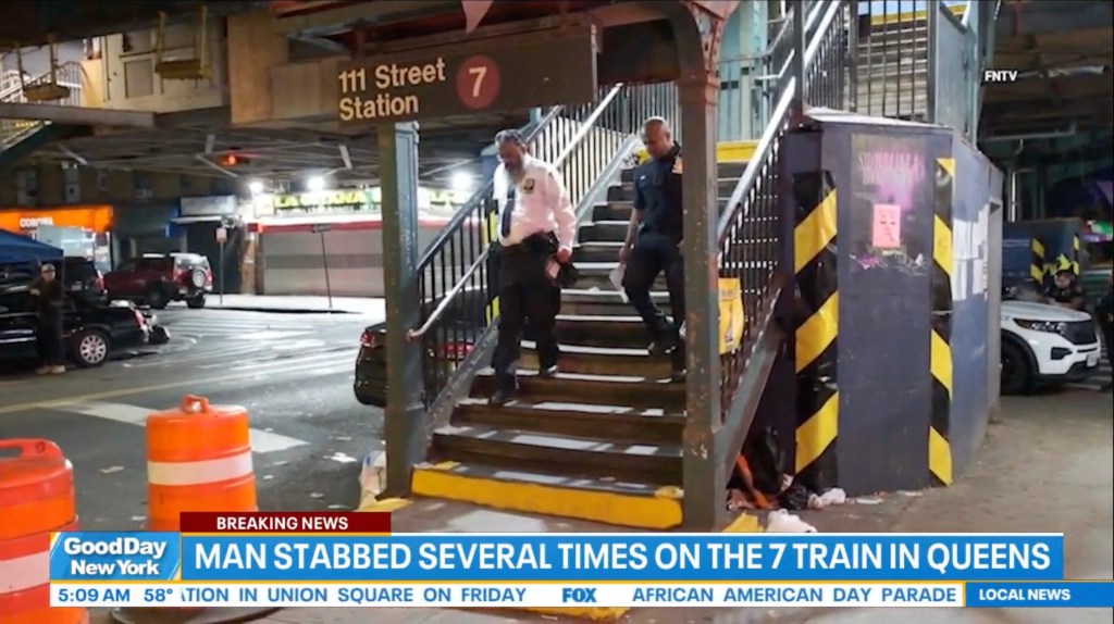 Police officers at the 111 Street subway station in Queens where a man was stabbed.