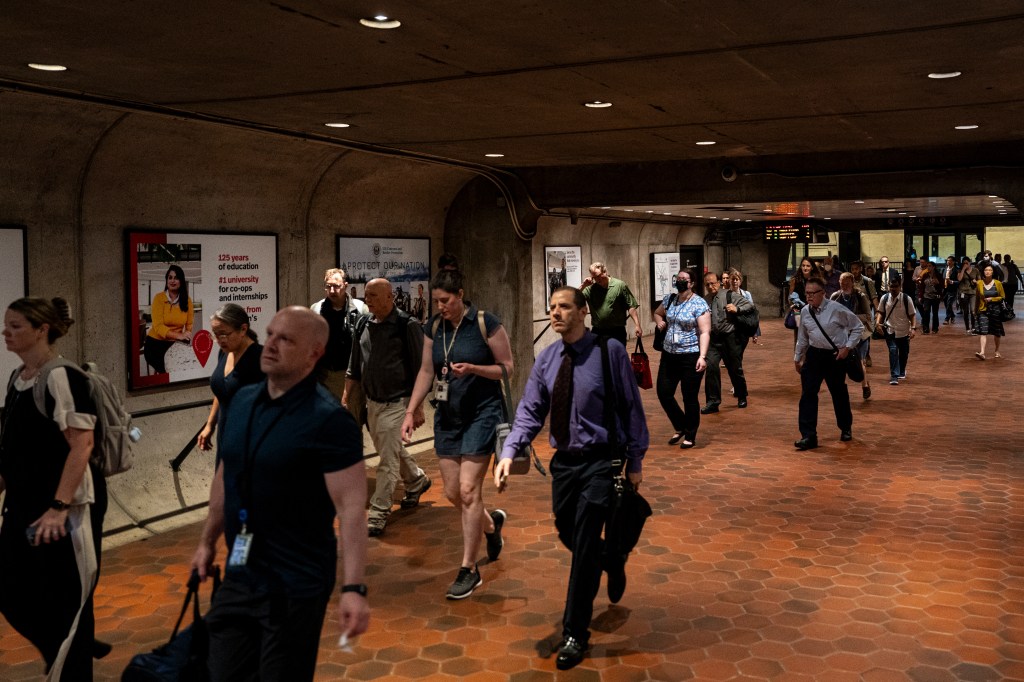 Commuters arrive at the Federal Triangle metro station in Washington, DC.