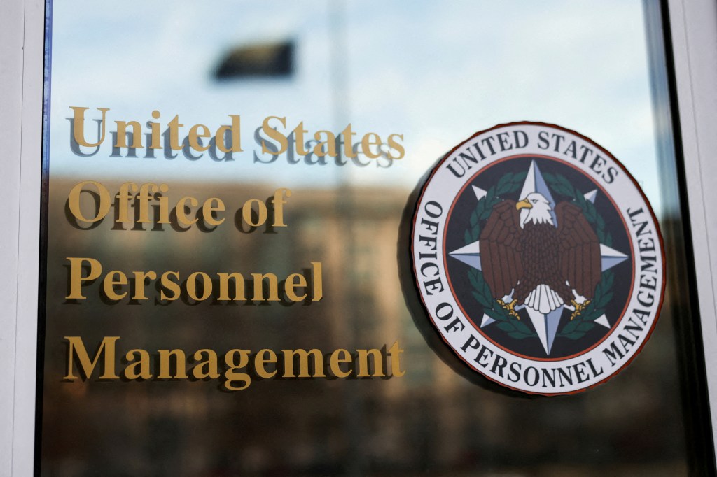 Office of Personnel Management (OPM) logo and text on a glass door.