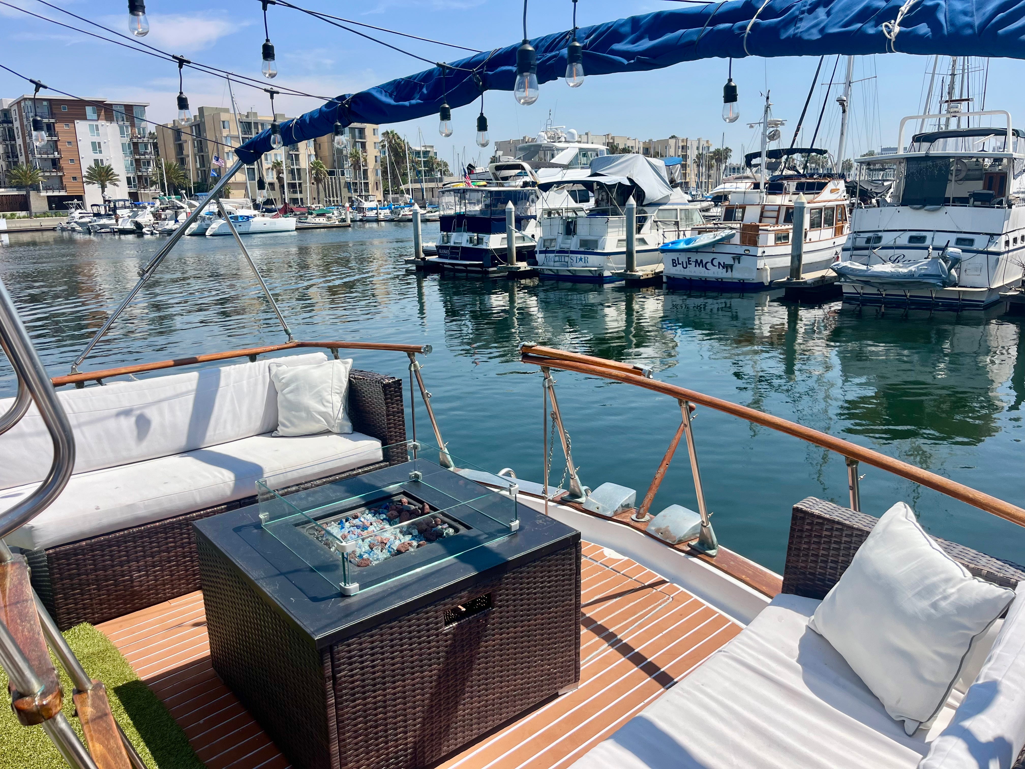 The boat's back patio with other boats in the marina.
