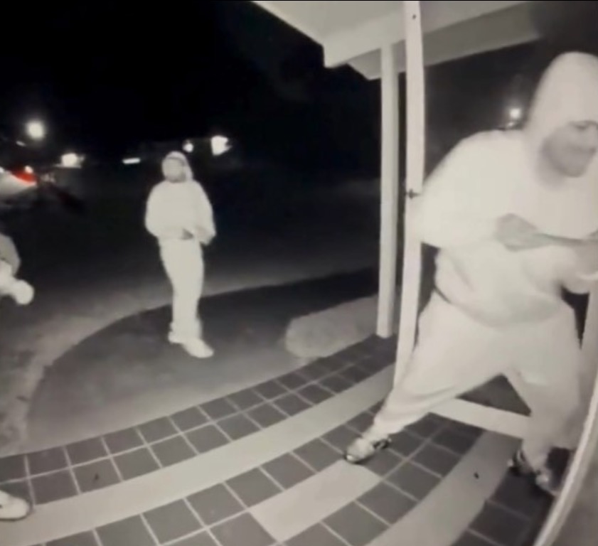 Surveillance video showing three suspects attempting to break into a home at night.
