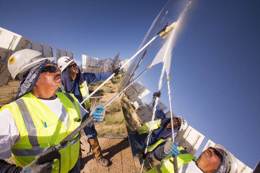 Workers washing heliostat mirrors at the Ivanpah Solar Thermal Power Plant.