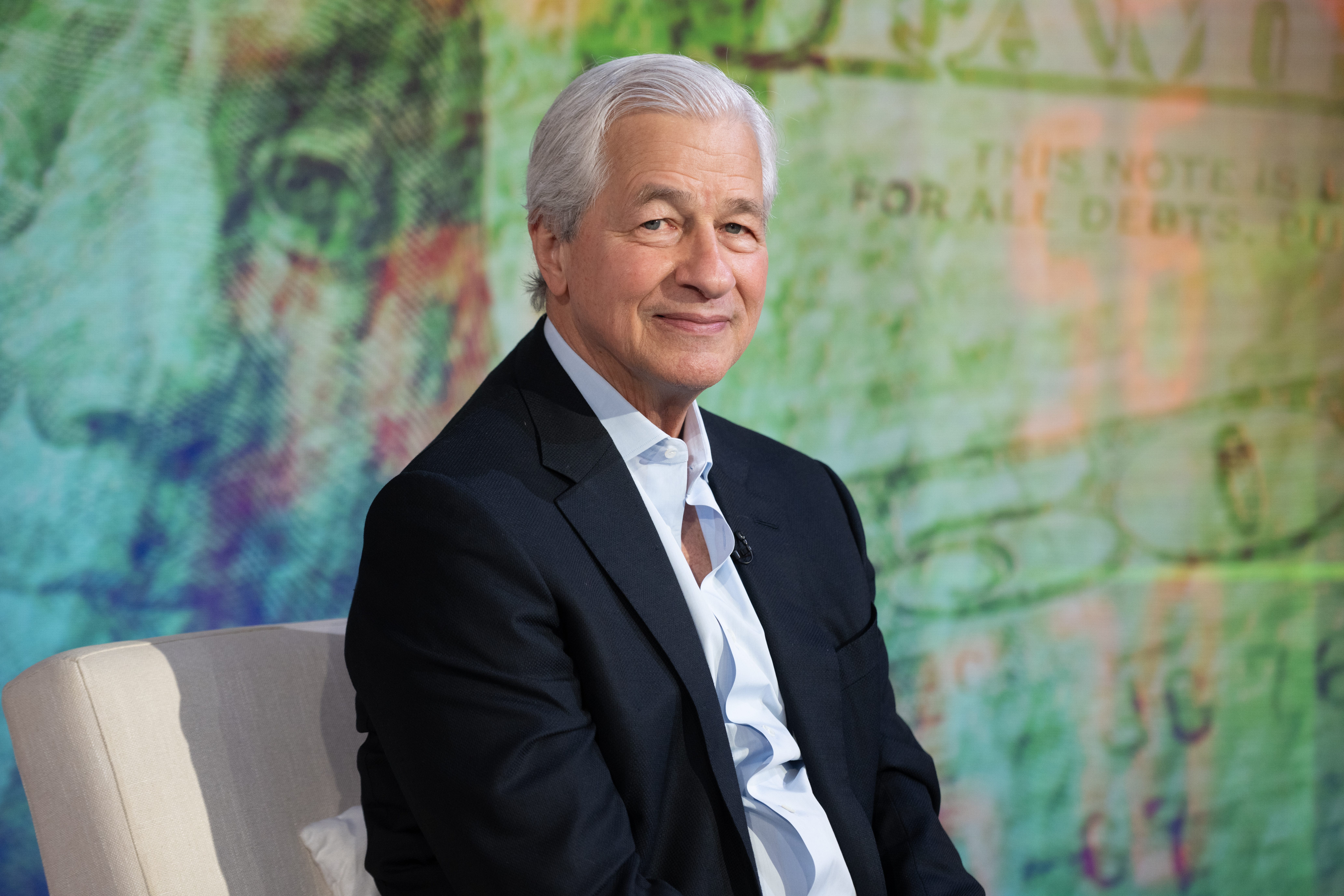 JPMorgan CEO Jamie Dimon sitting in a white sofa.