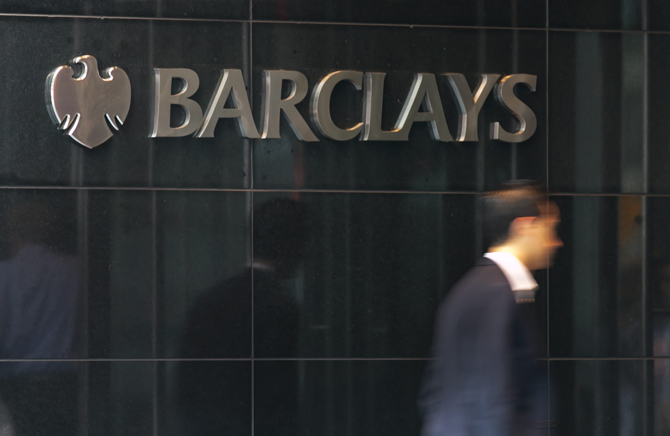 A man enters the New York headquarters of Barclays, Tuesday, July 22, 2014.