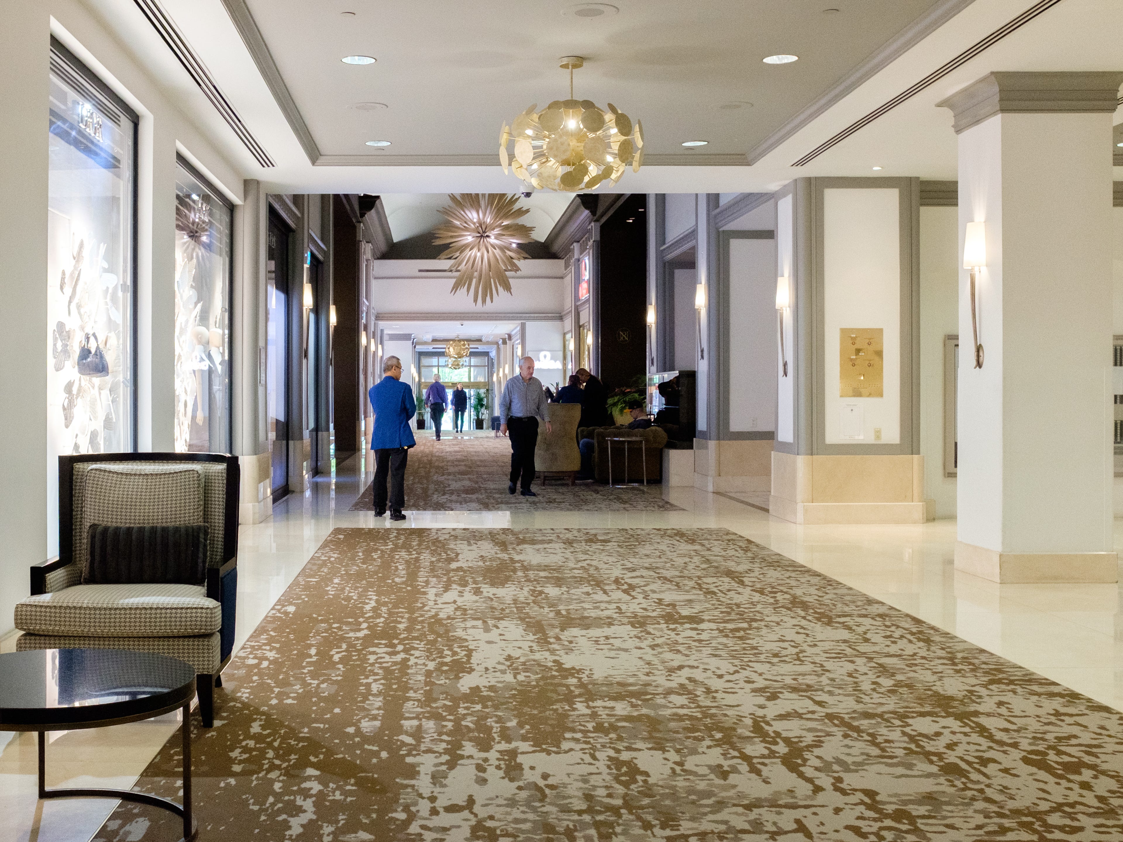 Inside the Fairmont Hotel Vancouver, there are modern chandeliers and white walls