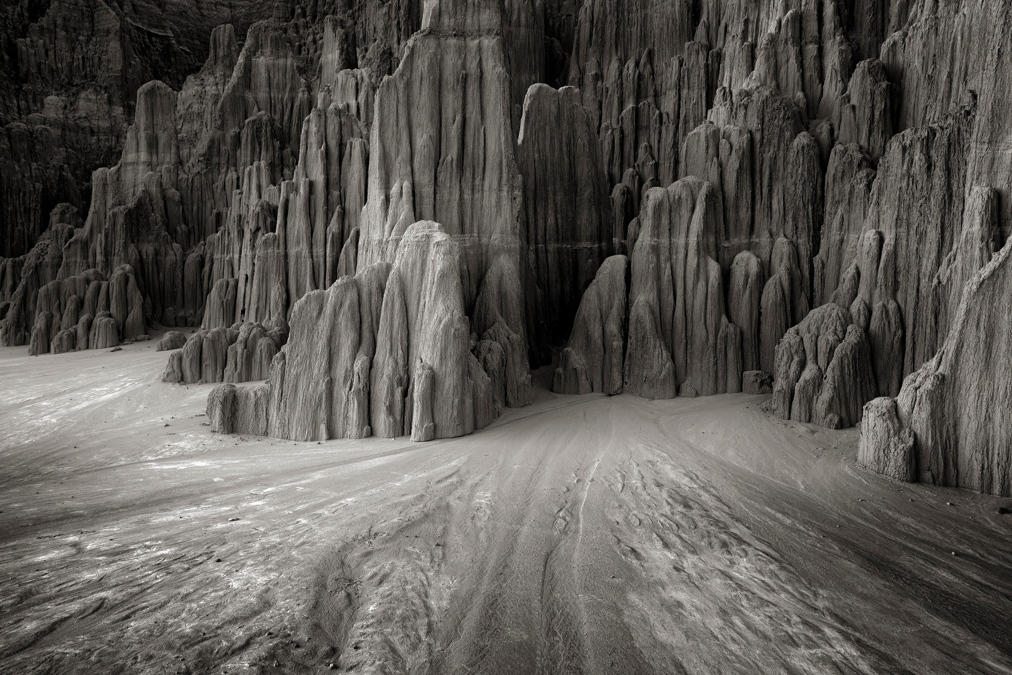 Erosion-worn rock spires stand above flat soil below.