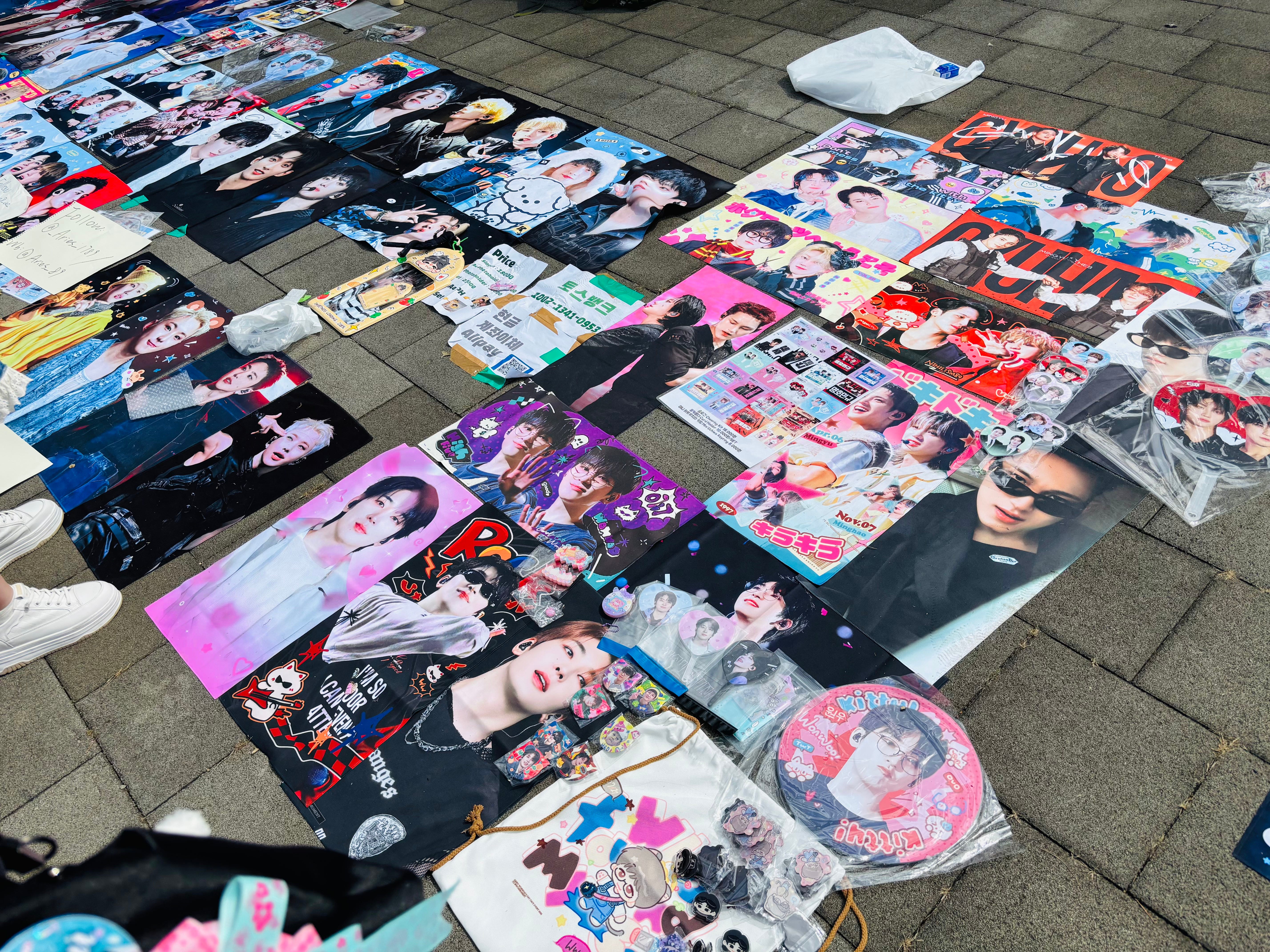 A top shot of the array of fan-made merchandise sold by fans outside Seventeen's concert.