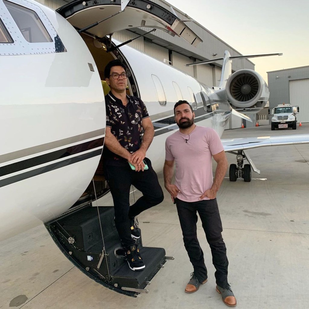 Tai Lopez and Alex Mehr standing in front of a private jet.