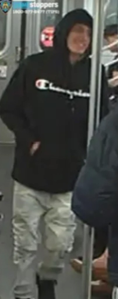Luis Pallchisaca, a 21-year-old male, wearing a black Champion hoodie and light-colored camouflage pants.