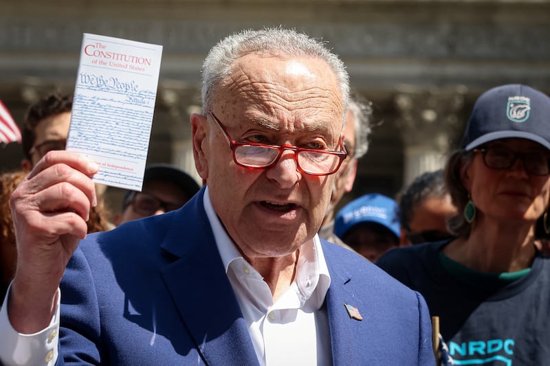 U.S. Senate Minority Leader Chuck Schumer, holds a copy of the U.S. Constitution as he speaks during a rally for Free Speech in Foley Square in front of Federal Courthouse in New York City, U.S., April 22, 2025.  REUTERS/Brendan McDermid