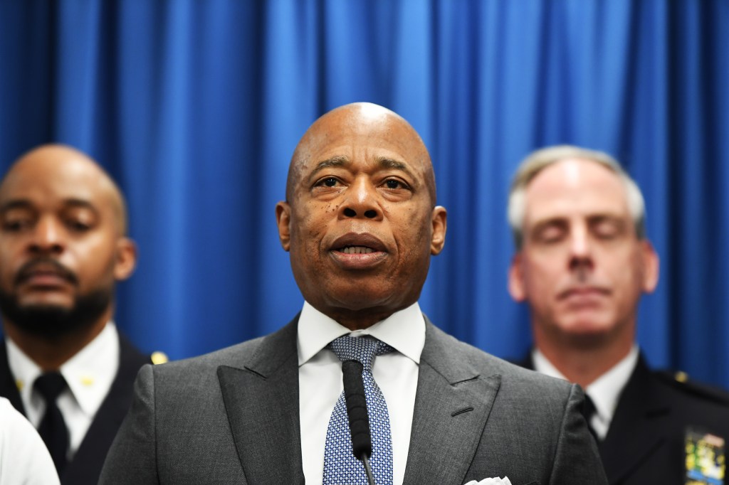 NYC Mayor Eric Adams speaking at a press conference with other officials.